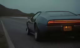 a dark, shadowy picture of a car sitting in the middle of the road