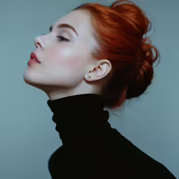 a woman with red hair, black sweater and large earring