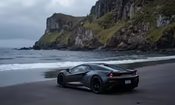 a car on the beach with the ocean in the background