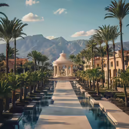 a pool area in front of several building with mountains