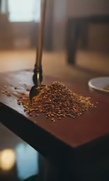 a wooden table with spices and a spoon