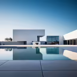 a view of a pool next to a building with a mirror on the side