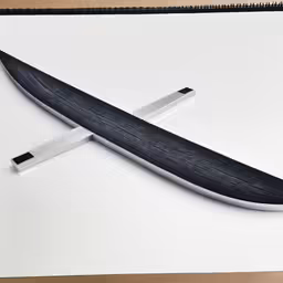 a knife with a black body on a desk