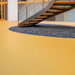 an indoor stair with an abstract design and yellow walls
