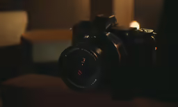 the camera is placed on a table with a light shining down
