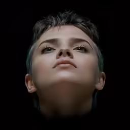 a young man looks upwards in the dark