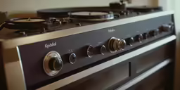 a close up of an oven with the top burners still on