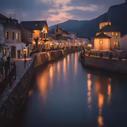 a body of water next to buildings at night