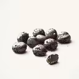 some chocolate covered candies on a white surface