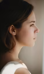 a woman is looking outside the window looking sad