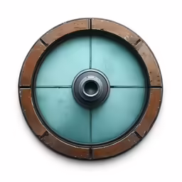 an old metal circle and round window with a small hole on top