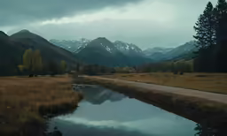 a road beside a body of water on a hillside