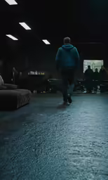a man is walking in a dark alley