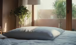 a bedroom has an indoor balcony and a white comforter on the bed