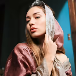 a woman with a very long hoodie covering her face