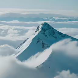 an image of a mountain covered in clouds