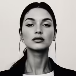 a black and white photo of a woman with a cigarette