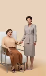 two women are sitting and shaking hands in the same chair