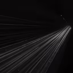 a black and white photo shows the light trails