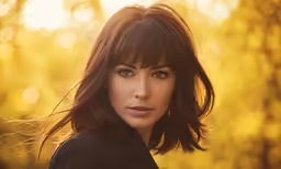 a woman standing in the forest with her eyes closed