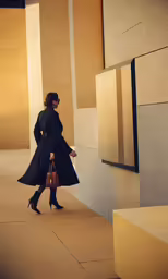 a woman in a long coat is walking