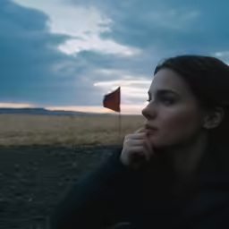a woman looking out at a field