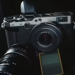 a camera and other electronics sitting on a table