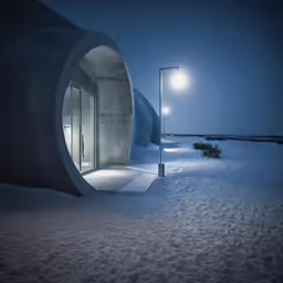 a building made out of concrete on the beach
