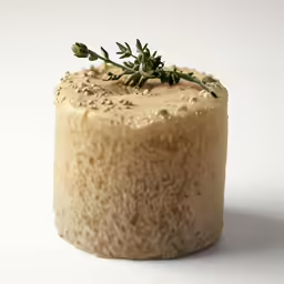 a round cake with sprigs of green on top
