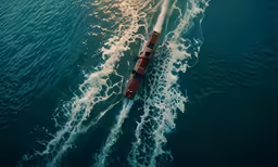 a boat going fast through the water, seen from above