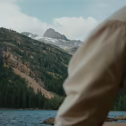 a boat is on the river with a mountain in the background