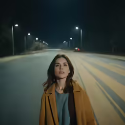 the girl standing in the middle of the road has her eyes closed