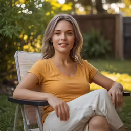 a girl sits on a chair outside in the sunlight