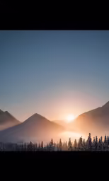 the sun is shining over a mountainous landscape