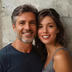 an attractive young couple pose for a studio photo