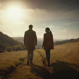 a man and woman walking together in an open field