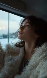 a girl in a car looks out the window