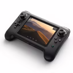 a black game controller on a white surface