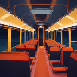 an orange and black bus is full of seats,the interior of a train car in an empty station