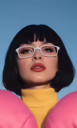 a woman in a pink shirt and white glasses wearing a pair of pink eyeglasses