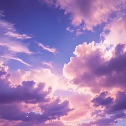 clouds and water with boats on the ocean below