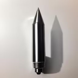 the black and silver cylindrical object is attached to a wall