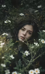 the woman is surrounded by white flowers