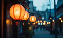 a group of lanterns hanging from the side of a building