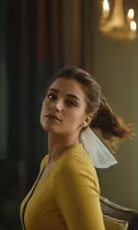 a girl is looking away in a dark room