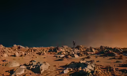 there is a man standing on the desert by rocks