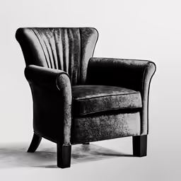 a black armchair in a grey room