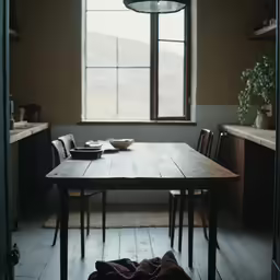 a wooden table sitting in front of a window