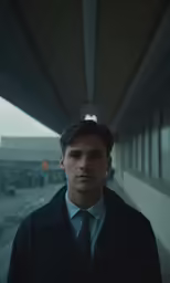 a man is looking straight ahead on the bridge