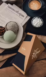 some chocolate donuts and various desserts on a table